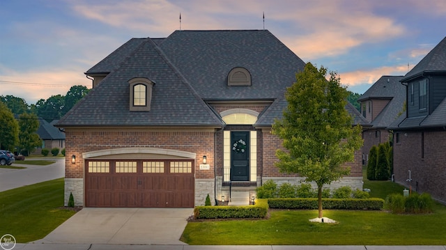 53081 Enclave Cir, Shelby Twp, MI 48315 - french provincial home with a front lawn, driveway, stone siding, and a garage