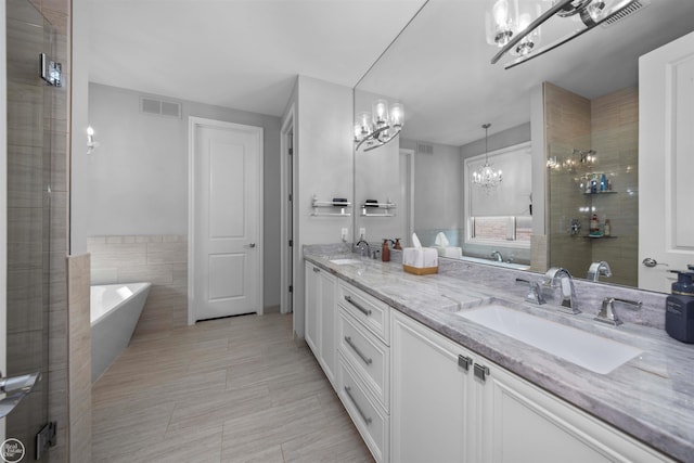 53081 Enclave Cir, Shelby Twp, MI 48315 - full bathroom featuring a chandelier, double vanity, a freestanding bath, a tile shower, and tile walls