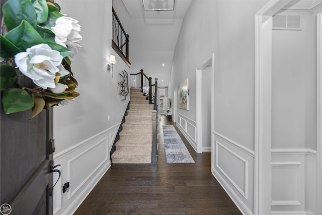 53081 Enclave Cir, Shelby Twp, MI 48315 - entryway featuring a decorative wall, wainscoting, stairway, and dark wood finished floors