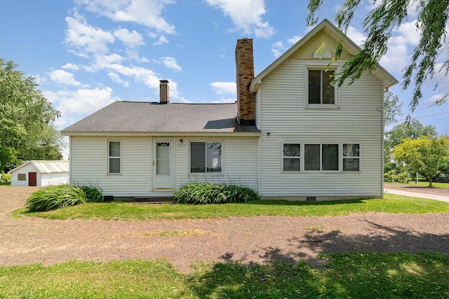 707 S Lincoln Rd, Bay City, MI 48708 - back of house featuring a chimney, crawl space, and a detached garage