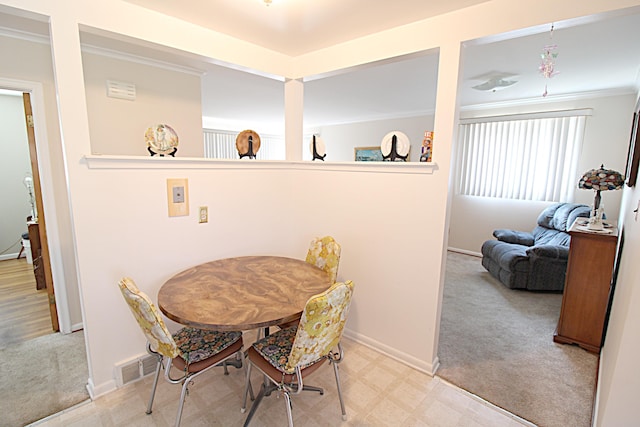 24849 Curie St, Warren, MI 48091 - dining space featuring light carpet, crown molding, and light flooring
