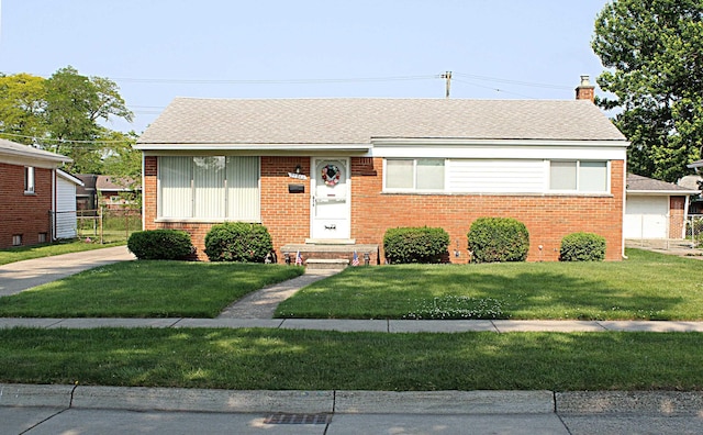 24849 Curie St, Warren, MI 48091 - view of front facade featuring brick siding, a chimney, a front yard, and a shingled roof