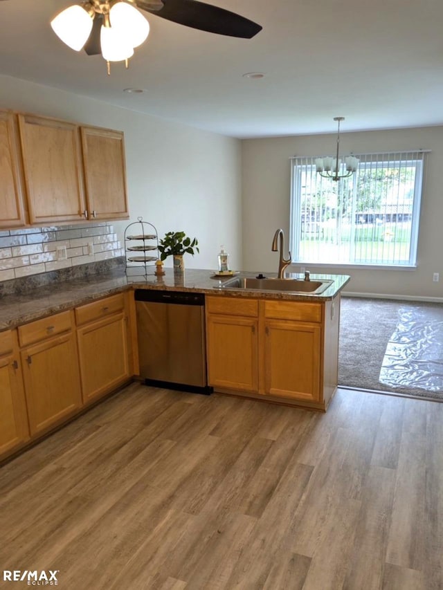 53168 Pineridge Dr, New Baltimore, MI 48051 - kitchen with stainless steel dishwasher, a peninsula, light wood-style floors, a chandelier, and ceiling fan