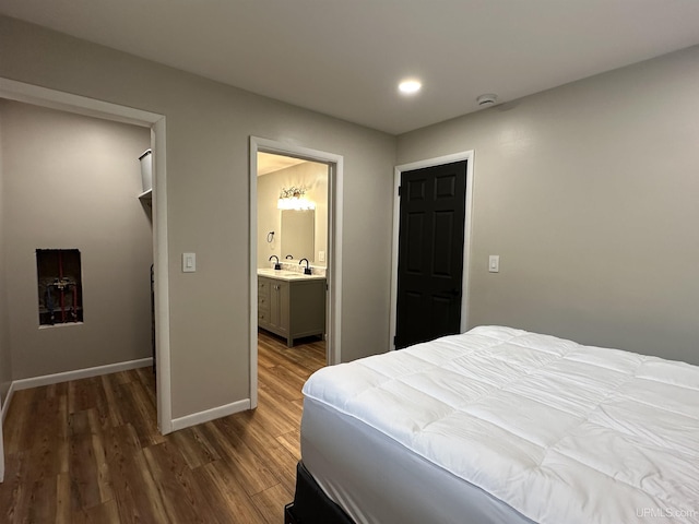 708 Paul Bunyan Ave, Ontonagon, MI 48853 - bedroom featuring wood finished floors, recessed lighting, and connected bathroom