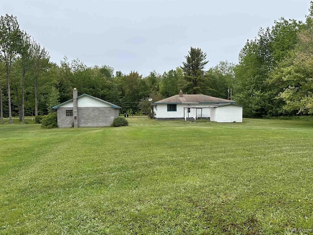 708 Paul Bunyan Ave, Ontonagon, MI 48853 - view of green lawn featuring a wooded view