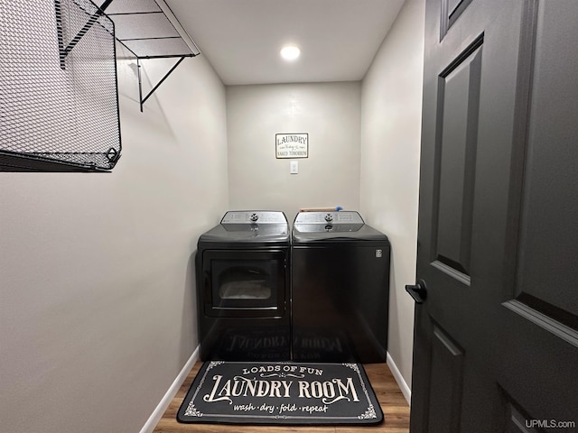 708 Paul Bunyan Ave, Ontonagon, MI 48853 - laundry room featuring washing machine and dryer and wood finished floors