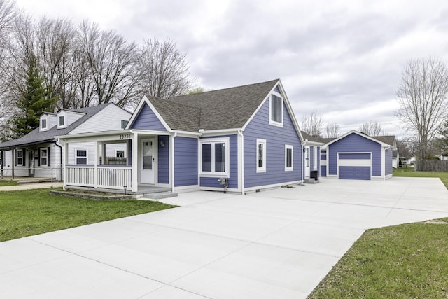 29230 Harding St, Roseville, MI 48066 - view of front of house featuring an outbuilding, concrete driveway, covered porch, a shingled roof, and a detached garage