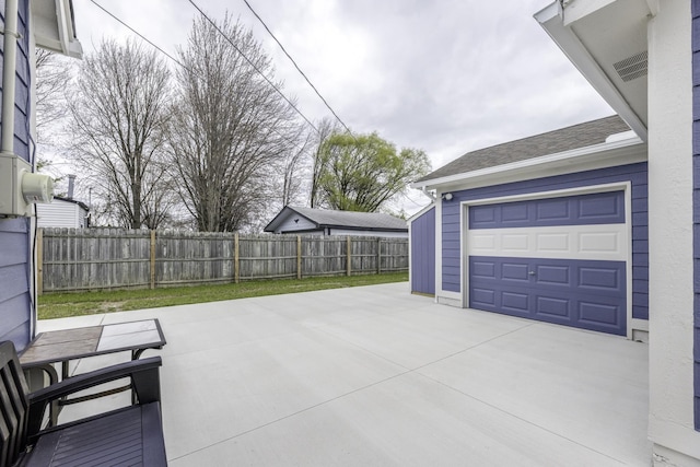 29230 Harding St, Roseville, MI 48066 - view of patio featuring a garage and driveway