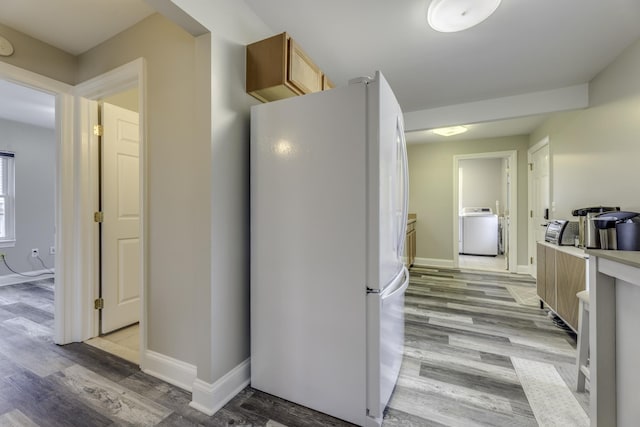 29230 Harding St, Roseville, MI 48066 - kitchen with freestanding refrigerator, washer / dryer, and light wood-type flooring
