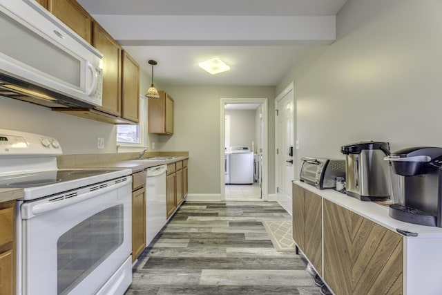 29230 Harding St, Roseville, MI 48066 - kitchen with white appliances, washer / dryer, brown cabinetry, and light wood finished floors