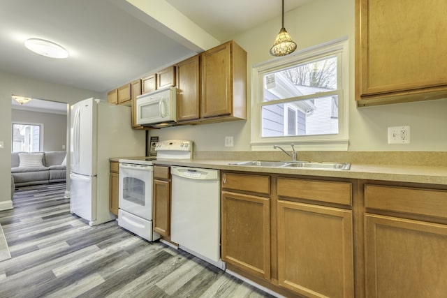 29230 Harding St, Roseville, MI 48066 - kitchen featuring white appliances, light wood-style floors, light countertops, and brown cabinetry