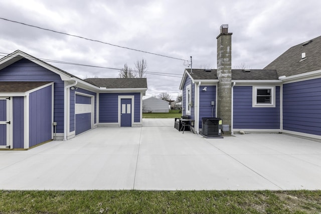 29230 Harding St, Roseville, MI 48066 - view of patio with an outdoor structure, concrete driveway, and a garage