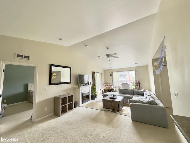 1922 Flagstone Cir, Rochester, MI 48307 - carpeted living room with lofted ceiling, a ceiling fan, and a glass covered fireplace