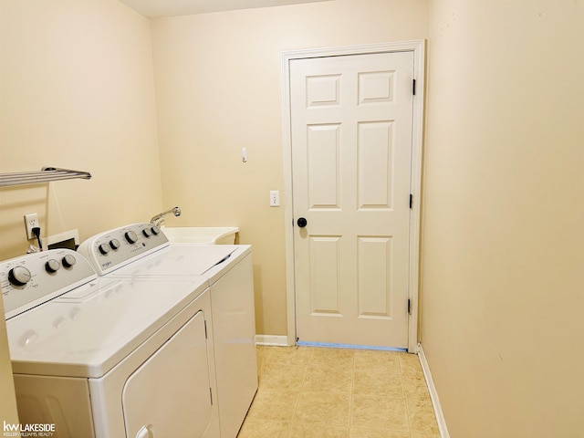 1922 Flagstone Cir, Rochester, MI 48307 - laundry room featuring washing machine and dryer and light tile patterned floors