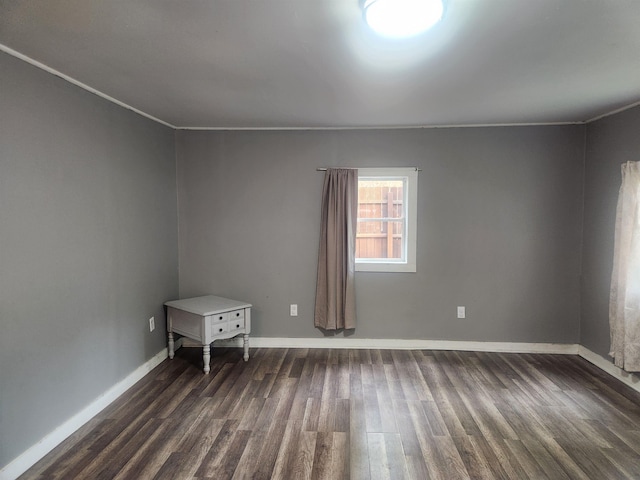 611 Pine St, Harrison, MI 48625 - spare room with dark wood-style floors and crown molding