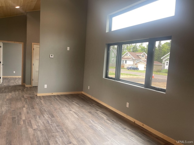 227 W Birch St, Ironwood, MI 49938 - spare room featuring a towering ceiling, wood finished floors, and wood ceiling