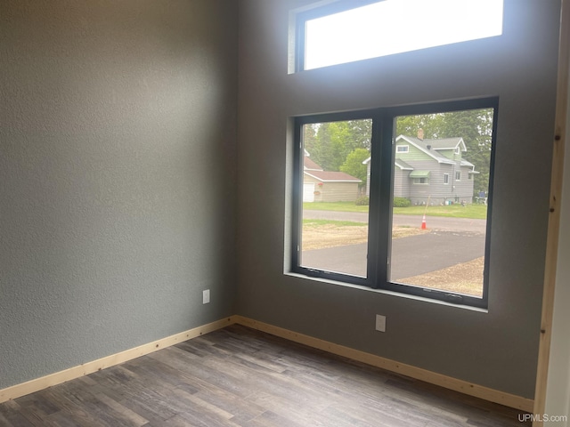 227 W Birch St, Ironwood, MI 49938 - unfurnished room featuring wood finished floors and a textured wall