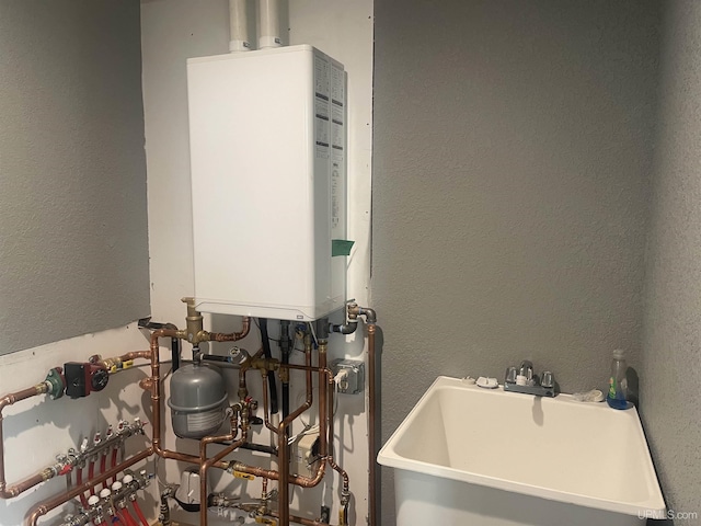 227 W Birch St, Ironwood, MI 49938 - utility room featuring water heater and a sink