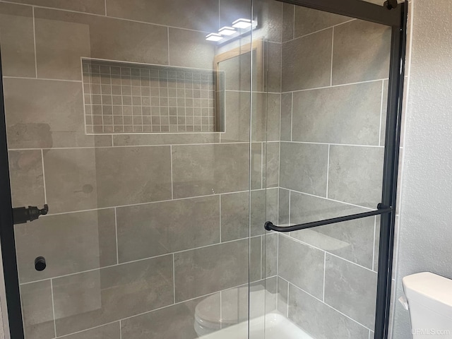 227 W Birch St, Ironwood, MI 49938 - full bathroom featuring toilet and tiled shower