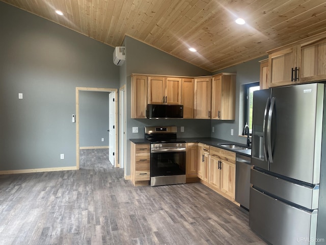 227 W Birch St, Ironwood, MI 49938 - kitchen featuring stainless steel appliances, dark countertops, vaulted ceiling, wood finished floors, and light brown cabinetry