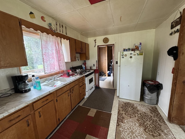 301 Kahma Ave, Amasa, MI 49902 - kitchen featuring white appliances, light countertops, light flooring, and brown cabinetry