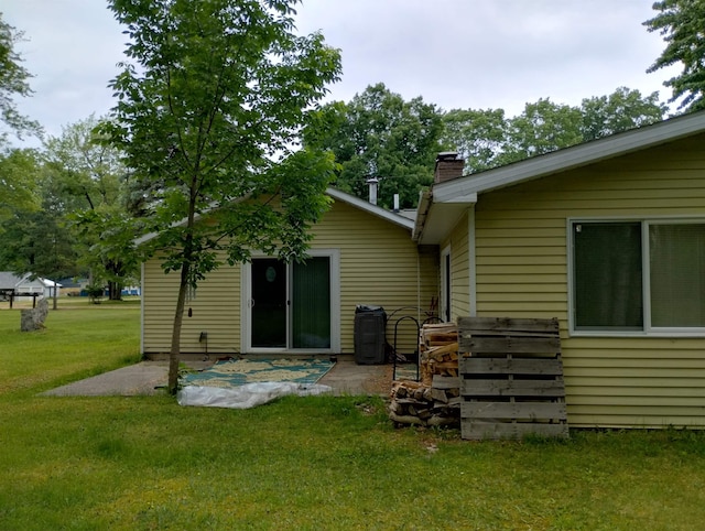 11131 Kaylynn Dr, Lake, MI 48632 - rear view of property with a lawn, a patio, and a chimney