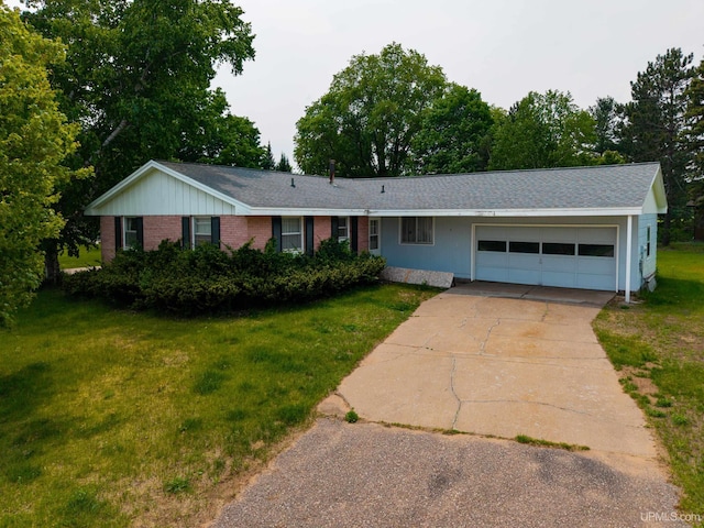3 Fairway Dr, Marquette, MI 49855 - ranch-style house featuring an attached garage, driveway, a front lawn, brick siding, and roof with shingles