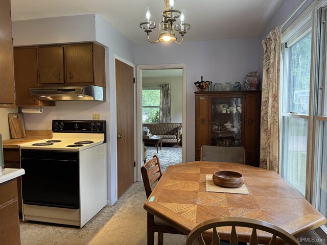 3 Fairway Dr, Marquette, MI 49855 - kitchen featuring electric stove, under cabinet range hood, light countertops, and a chandelier