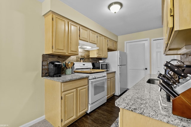 37576 Stonegate Cir, Clinton Township, MI 48036 - kitchen featuring white appliances, under cabinet range hood, backsplash, light stone countertops, and light brown cabinetry