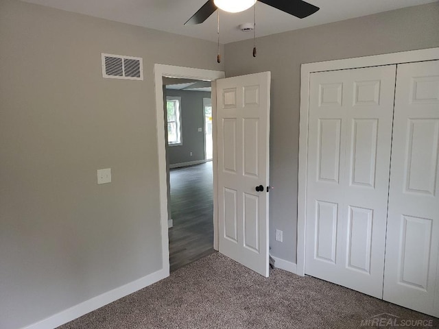 26593 Alray St, Chesterfield, MI 48051 - unfurnished bedroom with dark carpet, a closet, and ceiling fan