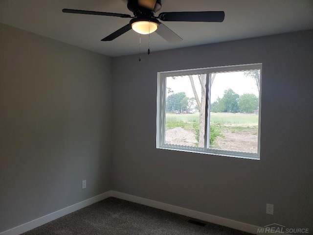 26593 Alray St, Chesterfield, MI 48051 - empty room with dark colored carpet and ceiling fan