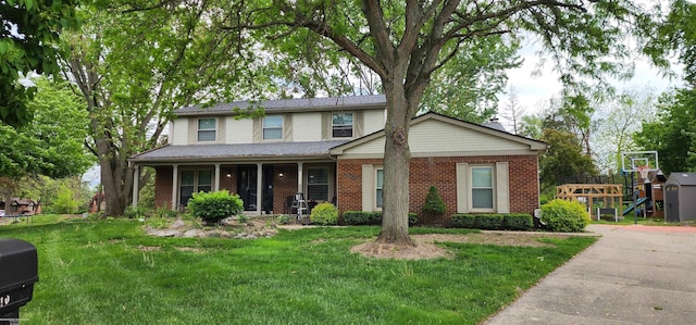 22410 Eaton St, Novi, MI 48375 - traditional-style house featuring brick siding, a front yard, and covered porch