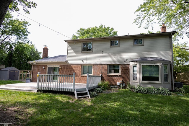 22410 Eaton St, Novi, MI 48375 - rear view of house featuring a chimney, a shed, brick siding, and a lawn