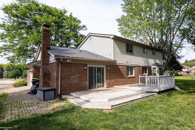 22410 Eaton St, Novi, MI 48375 - back of property with a chimney, brick siding, a yard, and a wooden deck