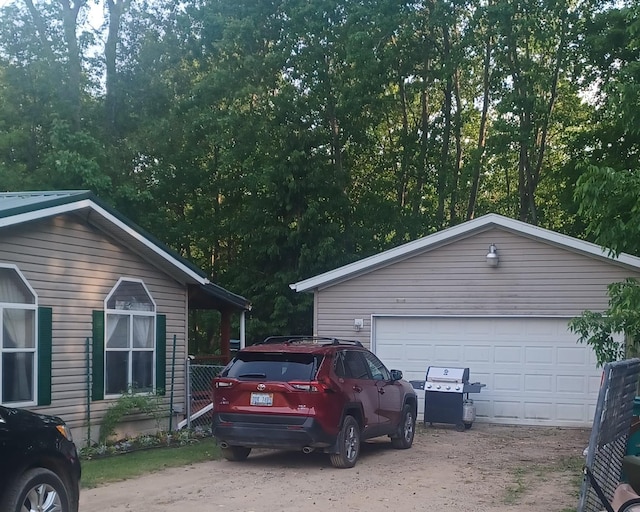 2145 Deer Lake Rd, Harrison, MI 48625 - view of side of home with a garage and an outdoor structure