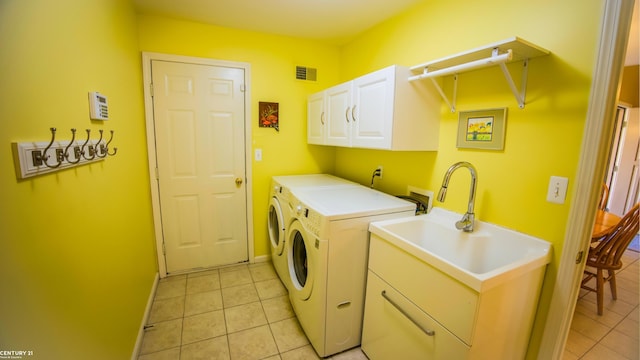 17485 Averhill Blvd, Macomb, MI 48042 - laundry area with washer and dryer, cabinet space, and light tile patterned flooring