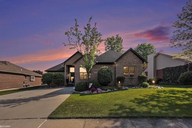 53564 Grace Dr, New Baltimore, MI 48047 - view of front of property featuring brick siding, a lawn, concrete driveway, and a shingled roof