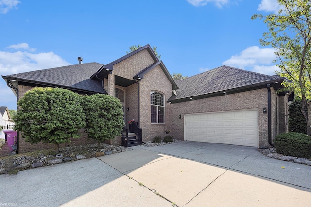 53564 Grace Dr, New Baltimore, MI 48047 - view of front facade featuring driveway, brick siding, a garage, and roof with shingles