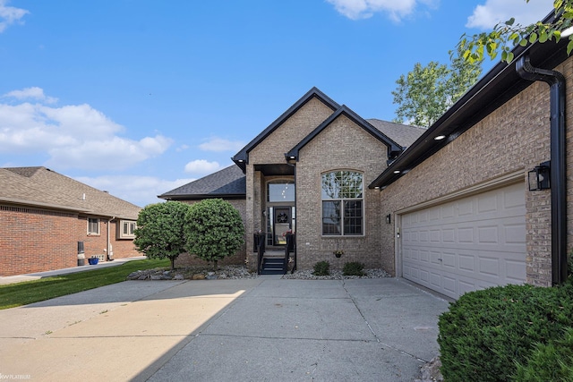 53564 Grace Dr, New Baltimore, MI 48047 - french country style house featuring concrete driveway, brick siding, and an attached garage