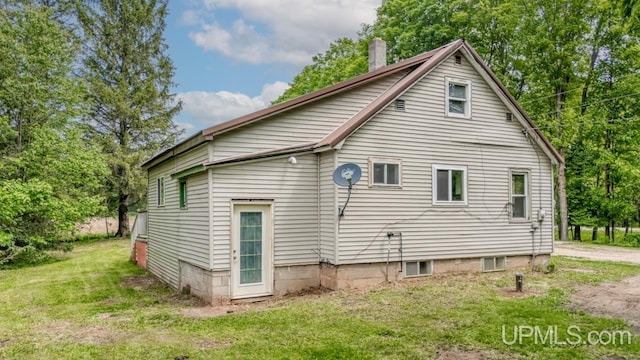N1953 M67 Hwy, Limestone, MI 49816 - rear view of property with a chimney and a lawn