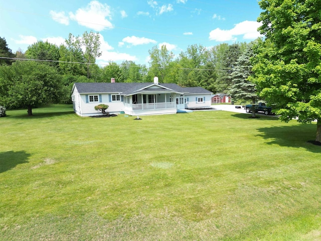 9470 Arbela Rd, Millington, MI 48746 - rear view of property featuring covered porch, a yard, a chimney, and view of scattered trees