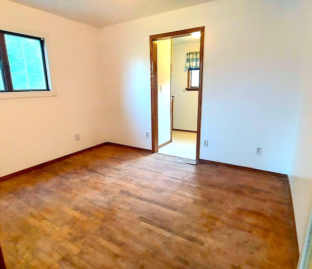 9470 Arbela Rd, Millington, MI 48746 - spare room featuring wood finished floors and baseboards
