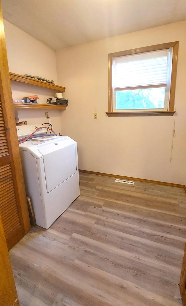 9470 Arbela Rd, Millington, MI 48746 - laundry area with washer / clothes dryer and light wood-style flooring