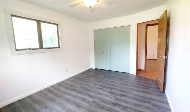 9470 Arbela Rd, Millington, MI 48746 - unfurnished bedroom featuring dark wood finished floors, a closet, and ceiling fan