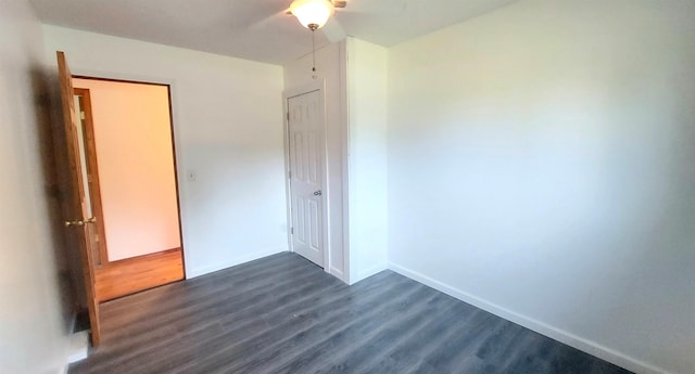 9470 Arbela Rd, Millington, MI 48746 - unfurnished bedroom with dark wood-style floors and baseboards