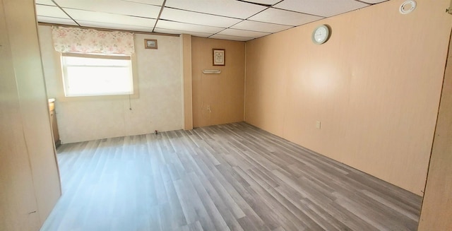 9470 Arbela Rd, Millington, MI 48746 - empty room with light wood-style floors, a drop ceiling, and a smoke detector