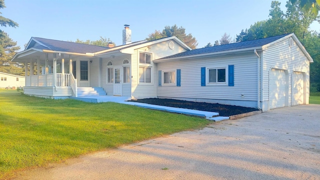 9470 Arbela Rd, Millington, MI 48746 - rear view of house with a porch, a chimney, a lawn, a garage, and concrete driveway