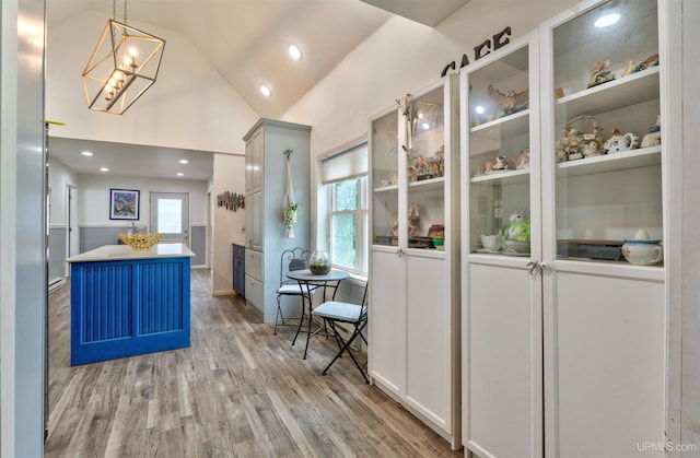 15951 Water St, Garden, MI 49835 - kitchen with light wood-style floors, plenty of natural light, a center island, vaulted ceiling, and a chandelier