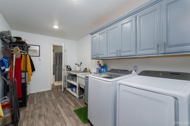 15951 Water St, Garden, MI 49835 - washroom featuring washing machine and clothes dryer, cabinet space, and wood finished floors