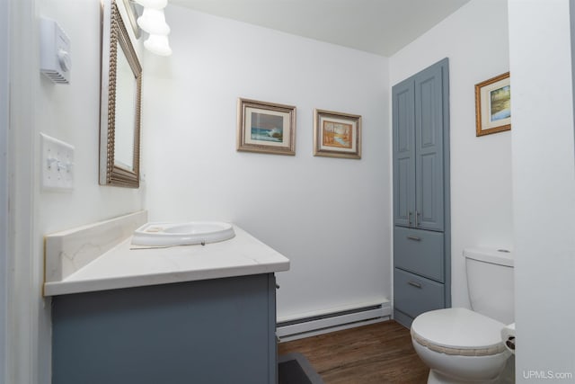 15951 Water St, Garden, MI 49835 - half bath featuring a baseboard radiator, vanity, and wood finished floors